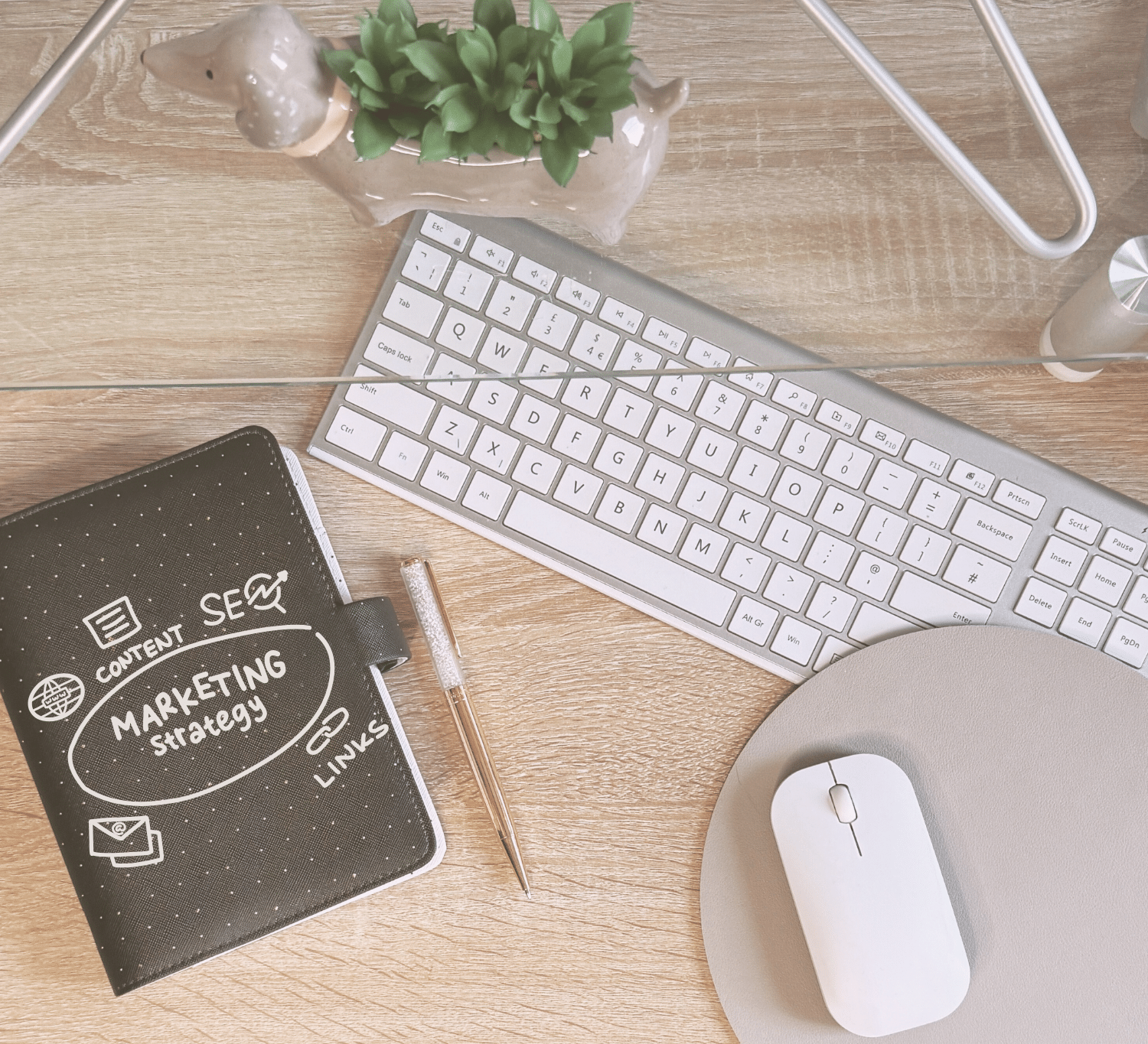 strategy notebookKeyboard and marketing strategy notebook showing SEO, content and links — digital marketing support for holistic wellness businesses by SD Virtual Solutions